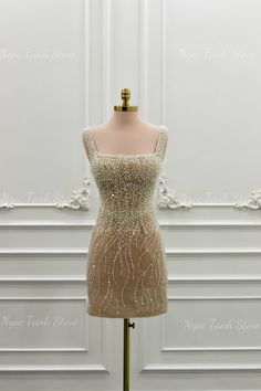 a dress on a mannequin stand in front of a white wall