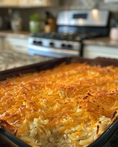 a casserole dish with cheese and onions in it sitting on a kitchen counter