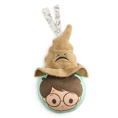 a stuffed toy with a hat on top of it's head and glasses hanging from the side