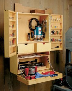 a workbench with tools in it and an electric driller on the shelf