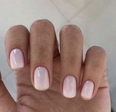 a woman's hand with pink and white nail polish