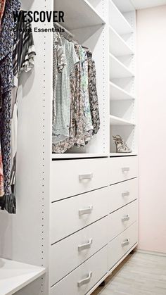 an organized closet with white shelving and clothes hanging on the wall, along with drawers