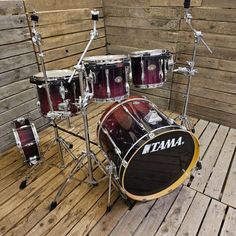 a set of drums sitting on top of a wooden floor