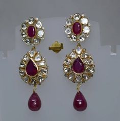 Ruby Gemstone, Uncut Polki Diamond Earring, Wedding Earring, 925 Sterling Silver, Gold Plated, Polki Earring, Ruby Earring, Polki Jewelry. Manufacture Country : India * Customization always available for Ring size, metal selection and any type of center stones changes, etc.... * If you want to make your own idea of Jewelry we can do it. Material : 925 Sterling Silver Main Stone : Ruby Secondary Gemstone : Polki, Pave Diamond Gemstone Color :   Gemstone Shape : As Seen In A Picture Weight : 29.65 gm * Shipment will dispatch within maximum 2-3 Days of Order done * Some Special customization can take more Time * UPS, DHL, FEDEX OR ARAMEX Will be available for Delivery Fine Jewelry Hallmarked Bridal Drop Earrings, Fusion Style White Gold Earrings For Wedding, Fusion Style White Gold Wedding Earrings, Sterling Silver Chandbali Wedding Earrings, Sterling Silver Hand Set Earrings For Wedding, Fusion Style Gemstone Chandelier Earrings For Wedding, Fusion Style Sterling Silver Bridal Earrings For Formal Occasions, Teardrop Diamond Earrings With Gemstone For Weddings, Diamond Teardrop Bridal Earrings With Gemstone