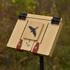 a small wooden box with a bird on it