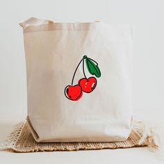 Cherry Tote, Cute Cherries Tote, Fruit Tote, Cherry Gifts Say goodbye to plastic, and bag your goodies in this organic cotton tote bag. There's more than enough room for groceries, books, and anything in between. * 100% certified organic cotton 3/1 twill * Fabric weight: 8 oz/yd² (272 g/m²) * Dimensions: 16″ × 14 ½″ × 5″ (40.6 cm × 35.6 cm × 12.7 cm) * Weight limit: 30 lbs (13.6 kg) * 1″ (2.5 cm) wide dual straps, 24.5″ (62.2 cm) length * Open main compartment * Blank product components sourced White Eco-friendly Canvas Bag For Grocery Shopping, Eco-friendly White Canvas Grocery Bag, Organic Cotton Canvas Bag For Gift, Organic White Reusable Bag, Organic Cotton Bag For Gift, Organic Cotton Bags For Gift, Organic Cotton Bags For Gifts, Organic Cotton Bags Gift, Recyclable Cotton Canvas Bag Gift