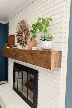 a white brick fireplace with potted plants on top