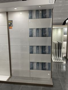 a white and blue tiled shower stall in a building