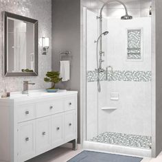 a bathroom with a walk in shower next to a white sink and mirror on the wall