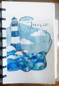 a drawing of a lighthouse and waves with the name juno written on it in blue ink