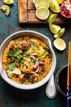 a bowl of food with chopsticks next to it