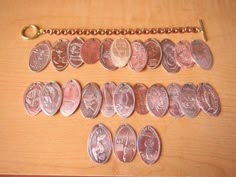 a bunch of different types of coins sitting on a table next to a key chain