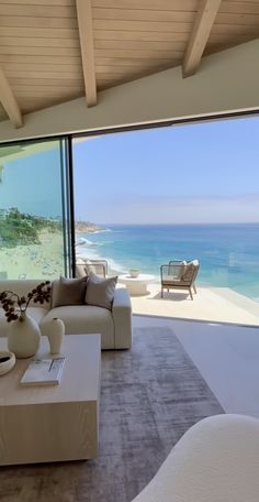 a living room with large windows overlooking the ocean