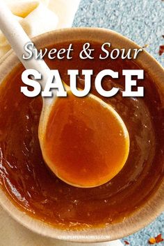 a spoon in a bowl filled with sauce and the words sweet & sour sauce above it