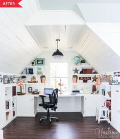 a home office with white walls and wooden flooring in an atticed room that also has shelving on the wall