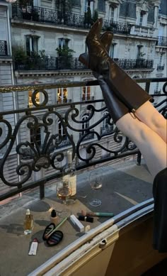 a woman laying on top of a window sill with her legs up in the air