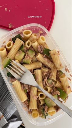 a plastic container filled with pasta and meat