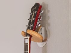 an electric guitar hanging on the wall