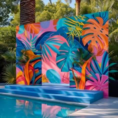 an artisticly designed pool with palm trees in the background