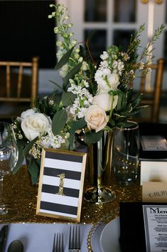 the table is set with silverware and flowers