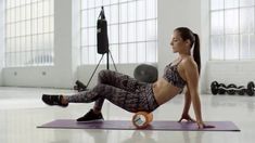 a woman is doing push ups on an exercise mat