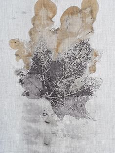 a piece of cloth with leaves on it and some brown stuff in the middle of it