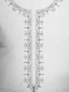 a drawing of a cross with flowers and vines on the side, in black and white