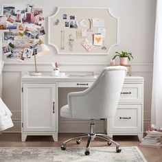 a white desk and chair in a room with pictures on the wall above it, along with a rug