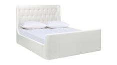 a white bed with two pillows on the headboard and one pillow on the foot board