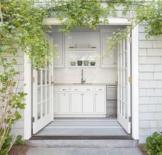 an open door leading into a white kitchen