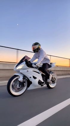 a man riding on the back of a white motorcycle