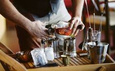 the bartender is preparing his drink for customers to enjoy at the bar or in the restaurant