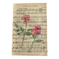 an old sheet music with pink flowers on it