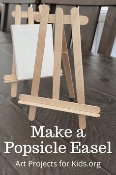 a wooden easel sitting on top of a table with the words make a popsicle ease