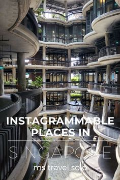 the inside of a large building with stairs and balconies in front of it