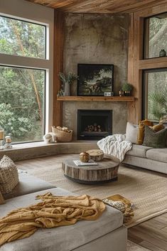 a living room filled with lots of furniture next to a fire place and large windows