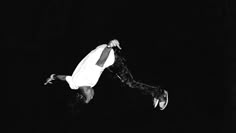 a man flying through the air while riding a skateboard in front of a black background