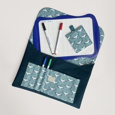 two pens and pencils in a pouch on a table