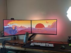 two computer monitors sitting next to each other on top of a wooden desk in front of a wall