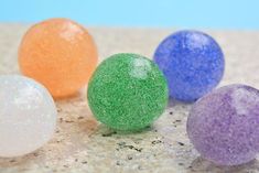 four different colored balls sitting on top of a counter