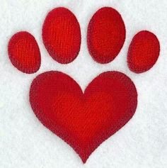 a red heart shaped paw print on white fabric