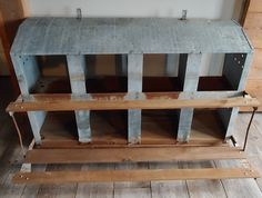 an old wooden bench sitting in front of a wall with metal bars on the sides