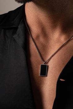 The 2mm Box Chain Black Enamel Necklace features a sleek square-shaped pendant with a sophisticated black enamel finish. This classic pendant necklace for men combines modern design with timeless elegance. Ideal as a gift for your husband or a stylish addition to any man's jewelry collection, it's perfect for both everyday wear and special occasions. * Made to order * Materials: Stainless Steel * Color: White Gold Plating * Chain Width: 2.0mm Approximately * Chain Length: 25" Inches Approximatel Classic Black Chain Jewelry, Classic Black Jewelry With Chain Detail, Classic Black Box Chain Necklace, Black Jewelry With Rectangular Box Chain Links, Minimalist Rectangular Necklace With Polished Finish, Rectangular Stainless Steel Necklace With Polished Finish, Rectangular Black Metal Jewelry, Black Curb Chain Necklace Gift, Minimalist Black Necklace With Curb Chain