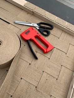 a pair of scissors sitting on top of a piece of cloth