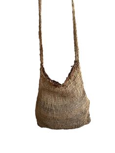 Experience the unique beauty and practicality of the Noken bag, a traditional handwoven bag from Papua, Indonesia. Made from natural fibers, each bag is a testament to the rich cultural heritage of the Papuan people. Woven Natural Fiber Basket Bucket Bag, Woven Basket Bucket Bag In Natural Color, Natural Woven Basket Bucket Bag, Handwoven Natural Straw Bag, Bohemian Jute Bag With Open Weave, Woven Bags Made Of Natural Fiber In Natural Color, Natural Woven Bags Made Of Natural Fiber, Woven Jute Basket Bag, Artisan Bucket Bag With Braided Handles In Natural Color