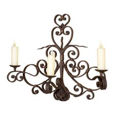 a wrought iron chandelier with three candles