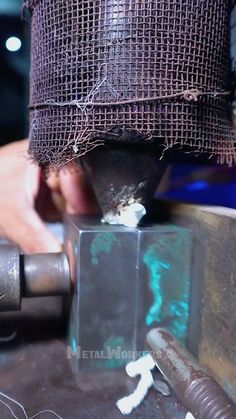 a man is working on an object in the process of making something out of metal