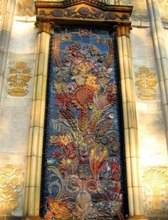 an ornate stained glass window on the side of a building