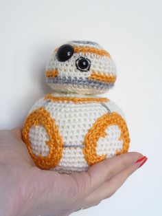 a crocheted star wars bbg toy is shown in the palm of a woman's hand