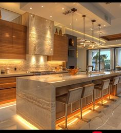 a large kitchen with an island in the middle and lots of counter space on each side